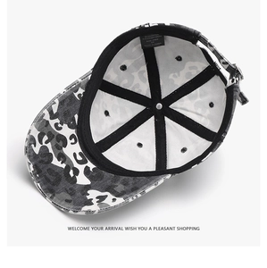 Detail of baseball cap interior showing camo pattern fabric, stitching, and care label
