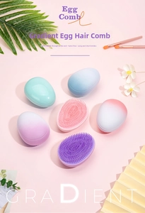 Close-up of ergonomic egg-shaped hair brushes with gradient colors and detangling bristles