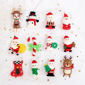 Close-up of 12 soft rubber Christmas cake toppers featuring Santa, elk, and snowman