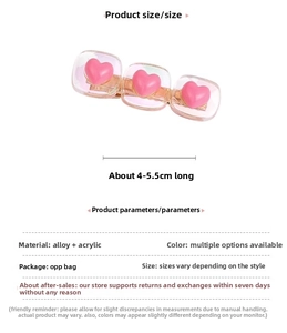 Detailed view of pink heart acrylic clips on a gold alloy base with 4-5.5cm dimensions