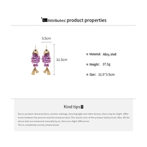Macro view showing dimensions of large purple shell fish-shaped drop earrings