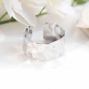 Elegant wide irregular hammered silver bangle in stainless steel for women