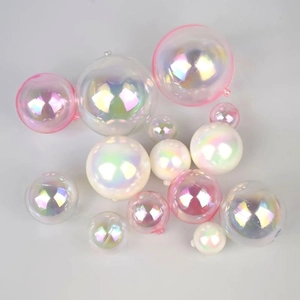 Detailed close-up of mixed size iridescent cake topper balls on a grey surface