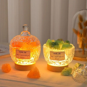 Macro detail of crystal glass diffusers with natural stones on a warm glowing LED base