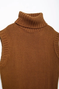 Detail of high-neck caramel knit sweater vest showing thick ribbed texture and premium wool
