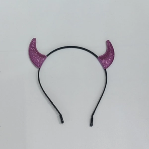 Detail of purple glitter devil horn headband featuring shimmering party texture