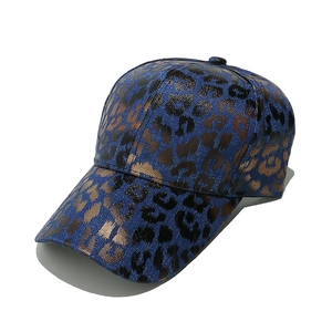 Detail of metallic leopard print pattern on high-quality navy blue baseball cap
