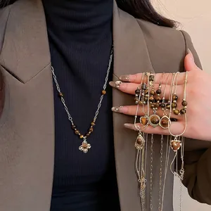Tiger eye flower pendant necklace worn by a model in a sophisticated office attire