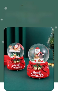 Detail of Christmas crystal ball music box with Santa and reindeer on red base
