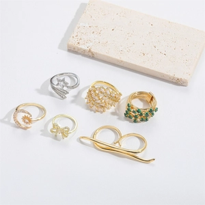 Detailed view of six adjustable star and moon rings in gold and silver finish