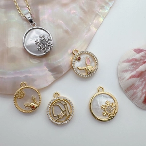 Elegant 18K gold plated shell pendants featuring snowflake, rabbit, and elk designs