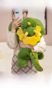 Detailed close-up of soft green triceratops plush showing plush texture and yellow horns