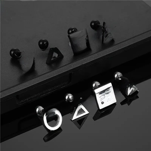 Detailed set of geometric titanium steel studs in matte black and polished silver finish