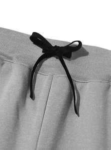 Close-up of the elastic waistband and drawstring detail on fleece cargo joggers