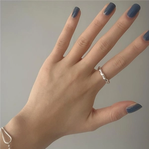 Detailed view of handmade 925 sterling silver knotted twist ring on a female finger