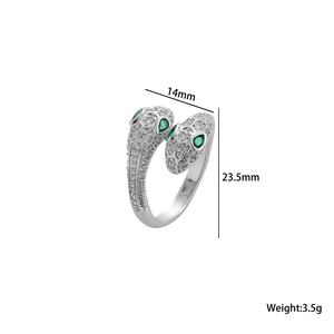 Detailed view of silver snake ring with green stone eyes and micro-pave zircon scales