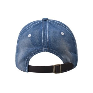 Detail of blue denim baseball cap showing leather back strap and white stitching
