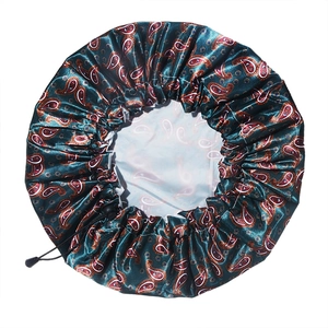 Detail of adjustable shower cap with green paisley satin and waterproof PEVA lining