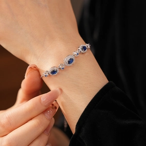 Macro view of vintage oval blue sapphire bracelet with silver zircon stone accents