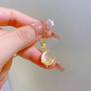 Elegant gold titanium necklace with crescent moon mother-of-pearl and crystal butterfly