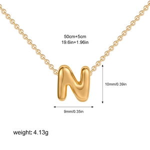 Detail of 3D bubble letter N pendant necklace showing 18k gold plating and measurements