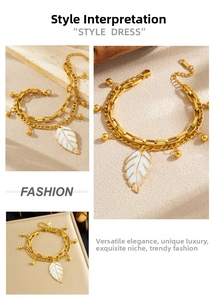 Detailed macro view of double-layer stainless steel chain with white leaf pendant charm