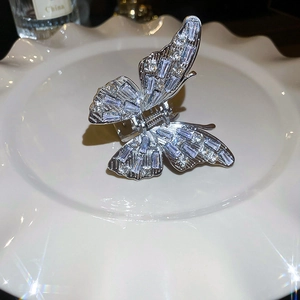 Detail of silver butterfly hair claw clip with zircon inlay and sparkling stones