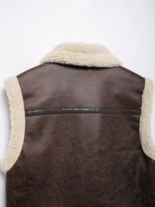 Detail view of brown faux leather vest showing premium texture and soft teddy fleece lining