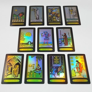 Detailed flat lay of eleven holographic tarot cards with gold edges on white background