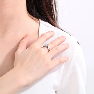Classic silver six-prong diamond engagement ring shown on a finger with a polished finish