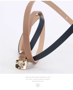 Detailed coiled display of khaki and navy PU leather thin belts with golden buckles