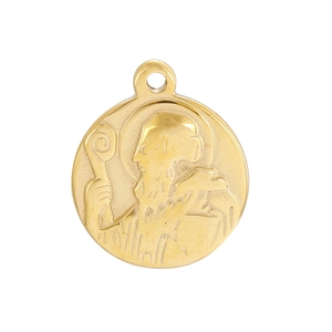 Detail of a vintage gold-tone round medallion featuring an embossed religious Saint portrait