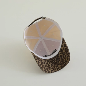 Close-up of kids baseball cap inner structure with leopard brim and letter embroidery