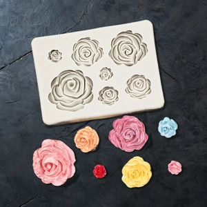 Macro detail of food-grade 3D rose silicone mold with finished colorful flower samples