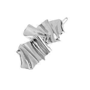 Detailed close-up of textured silver hair clip showing the metallic fold pattern and finish