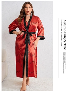 Detail showing the red satin sleepwear fabric with love patterns and black trim accents
