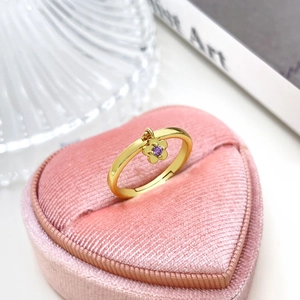 Exquisite 18k gold plated flower ring with purple zircon on a pink velvet heart box