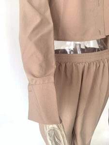 Close-up of elastic waistband details and khaki woven fabric on women's two-piece set