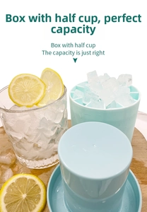 Top view of blue silicone ice bucket mold with fresh lemon and a glass of ice
