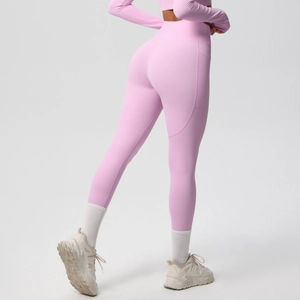 Detail of high-waisted yoga leggings in pink with functional side pockets and seam lines