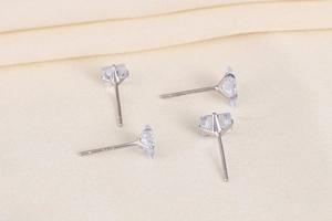 Detailed view of four square-cut cubic zirconia stud earrings in sterling silver finish