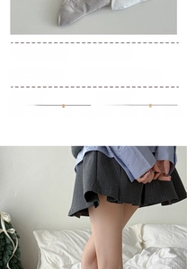 Detail of grey crew socks with 3D bear design and grey pleated skirt styling