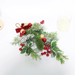 Close-up of Christmas teardrop swag with red velvet bow, pine needles and berries