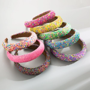 Detail of candy-colored padded headbands with colorful textured sprinkles and velvet lining