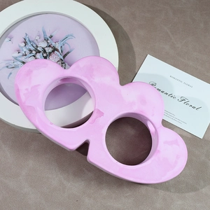 Detail view of heart-shaped marble pattern ceramic flower vase with dual openings