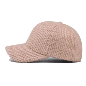 Beige knit baseball cap with cozy fleece lining and classic curved brim for winter
