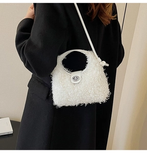 Close-up of white plush crossbody bag showing soft faux fur texture and silver metal lock
