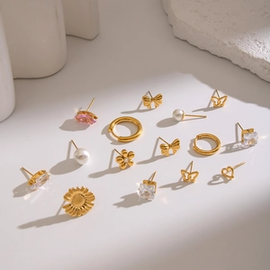 Elegant gold earrings set featuring pearls, pink zircon butterflies, hearts and flower studs