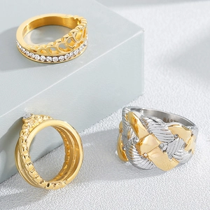 Three-piece set of gold-colored vintage rhinestone rings on geometric props display