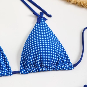 Close-up of blue gingham bikini top with bow detail and adjustable halter ties